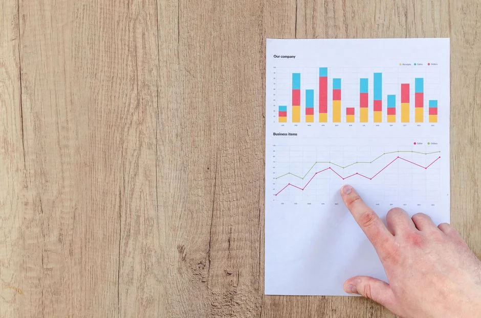 Team working on marketing strategy using data charts and papers in an office meeting.